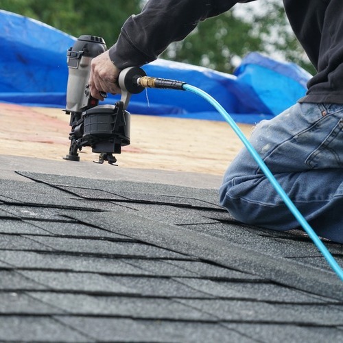 A Roofer Replaces Shingles.