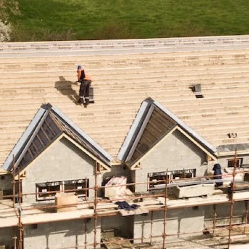 A Roofer Works on a New Roof