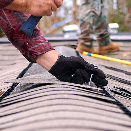 Roofer Works on an Asphalt Shingle Repair.